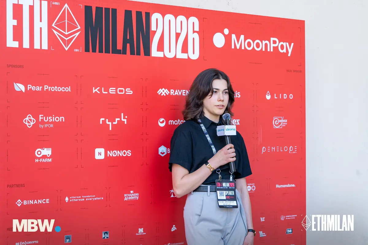 A speaker interviewed in front of the ETHMilan 2026 sponsor wall